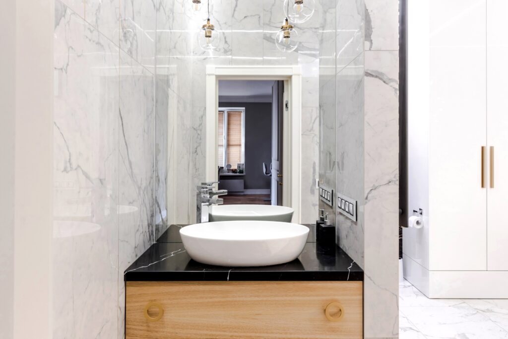 Stylish modern luxurious marble bathroom with original fixtures and a washbasin